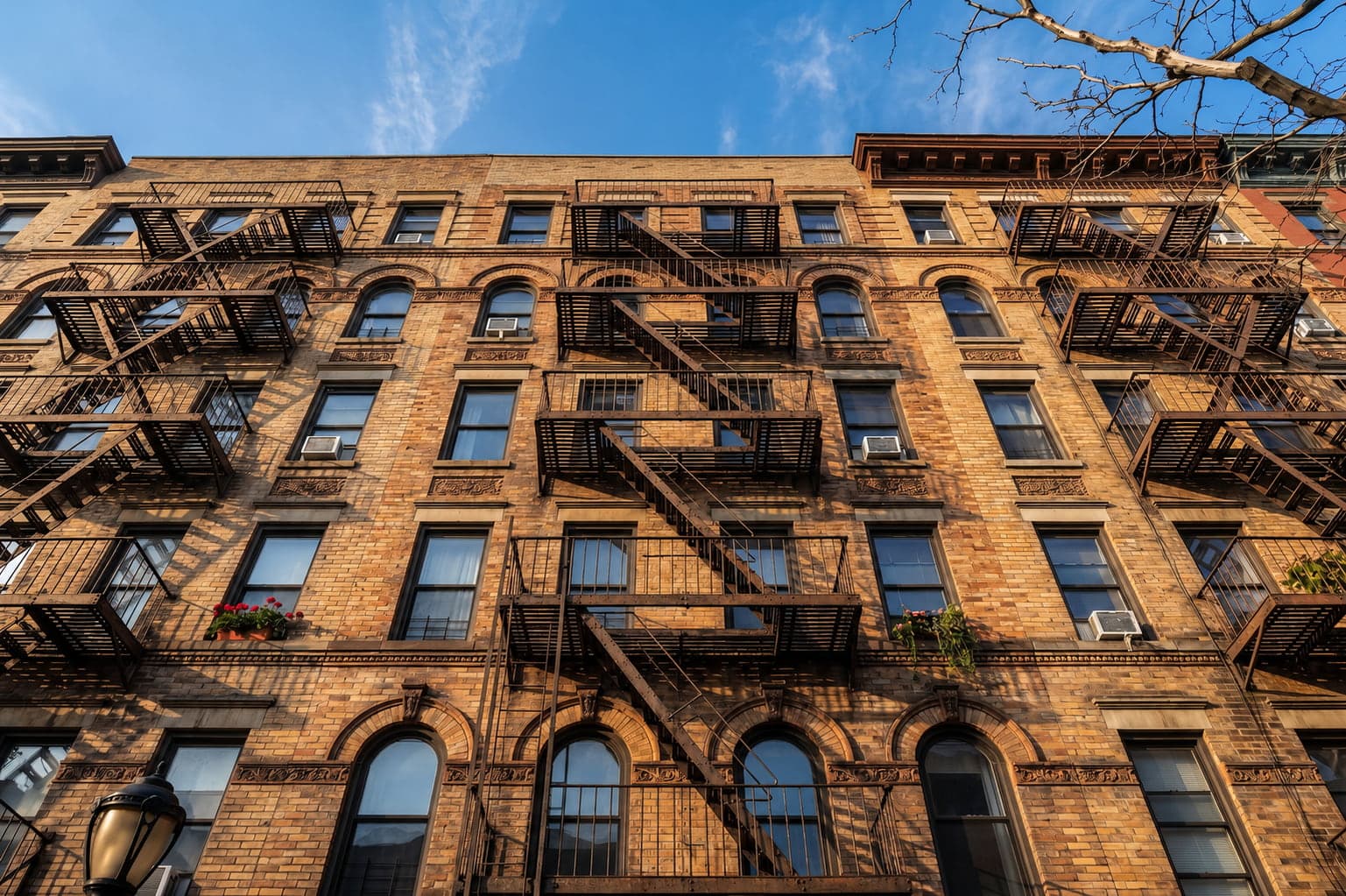 NYC brownstone townhouse with classic stoop and tree-lined street